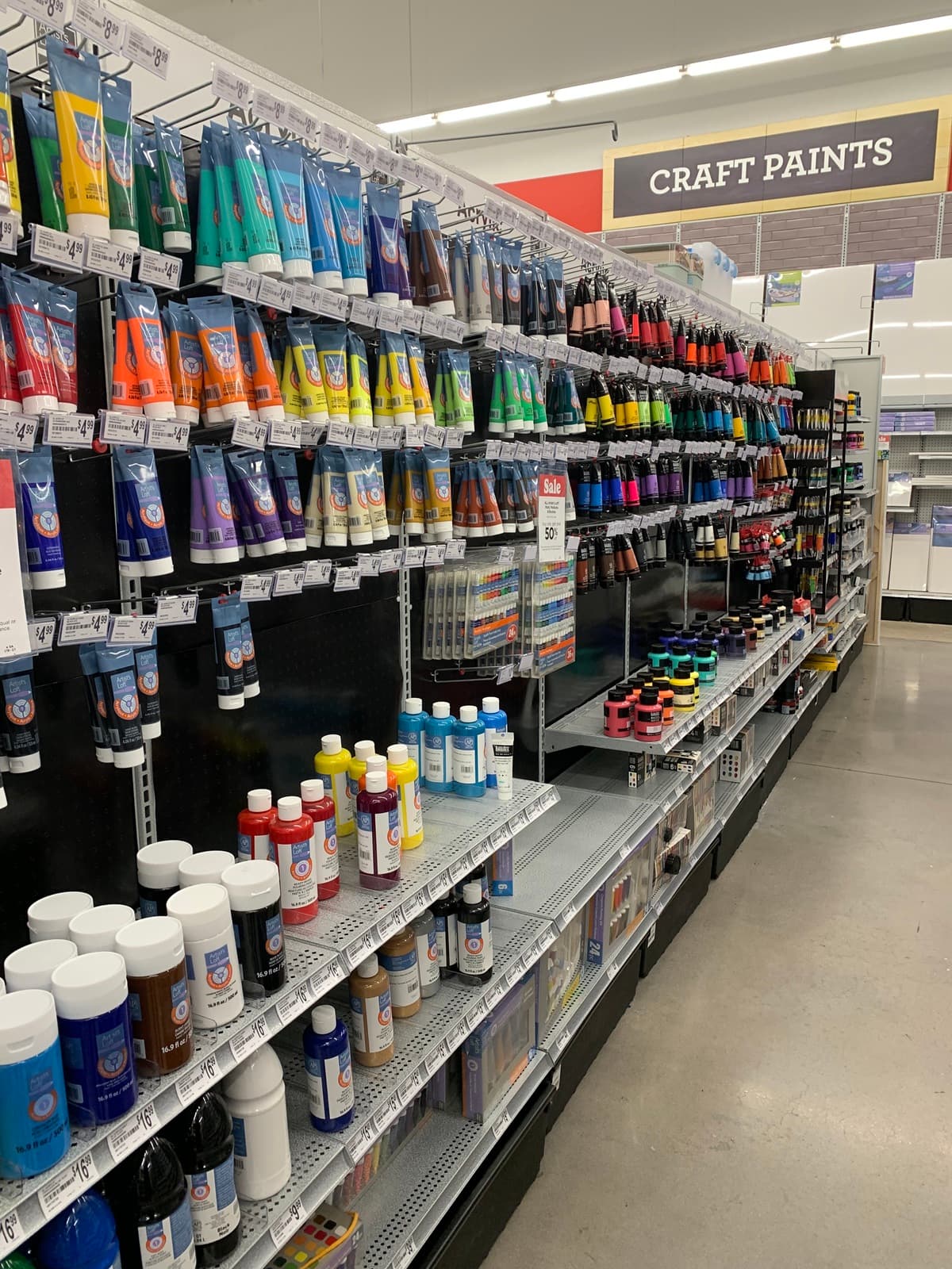Shelves of craft paints in an artisan studio, the creative fine art background behind Sun & Rain Works